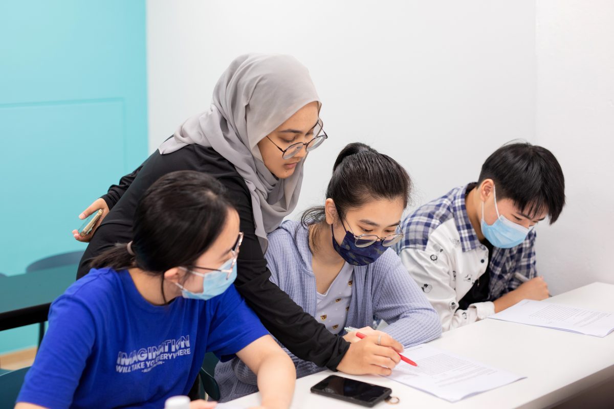 Teacher Alya giving close feedback during O Level English tuition