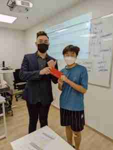 Secondary School student winning a prize in class