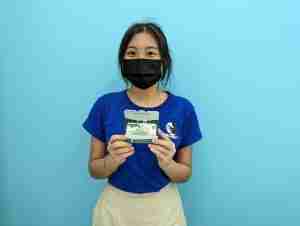 Student from Hwa Chong winning a prize in class