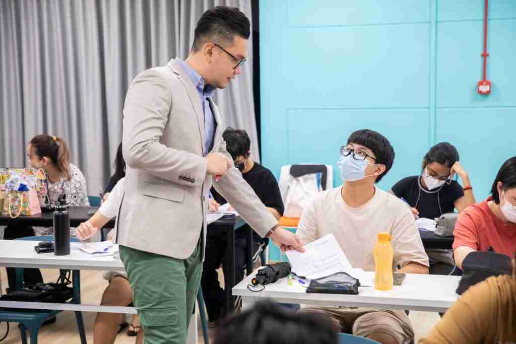 Mr Chia giving students direct feedbak during IP English Language Arts Tuition
