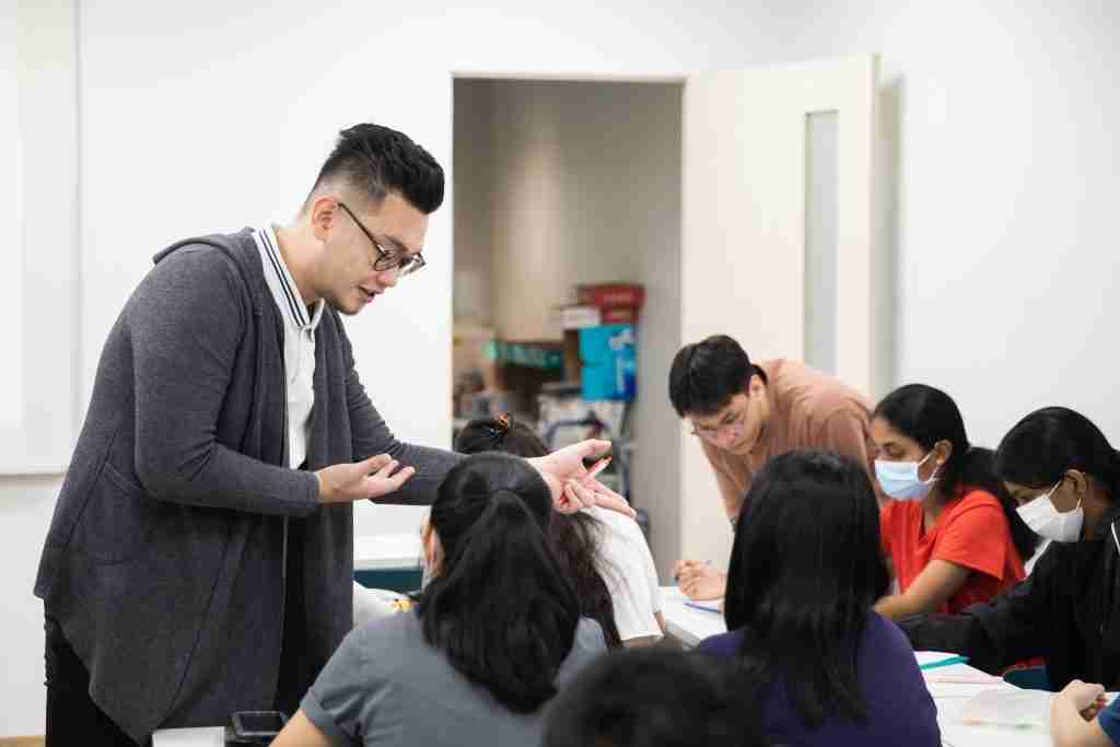 Students receiving close feedback from different teachers during GP class from Mr Chia and Mr Liew