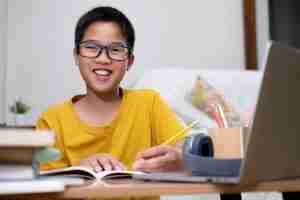 smiling primary six student studying for PSLE