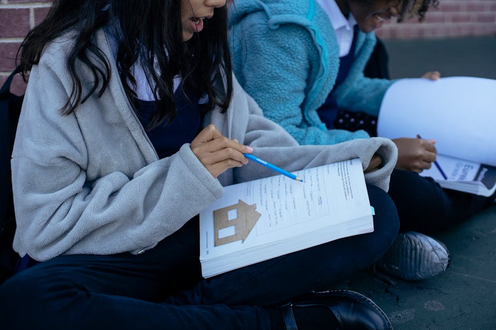 young students sitting down and studying together