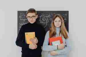two junior high school students holding studying essentials