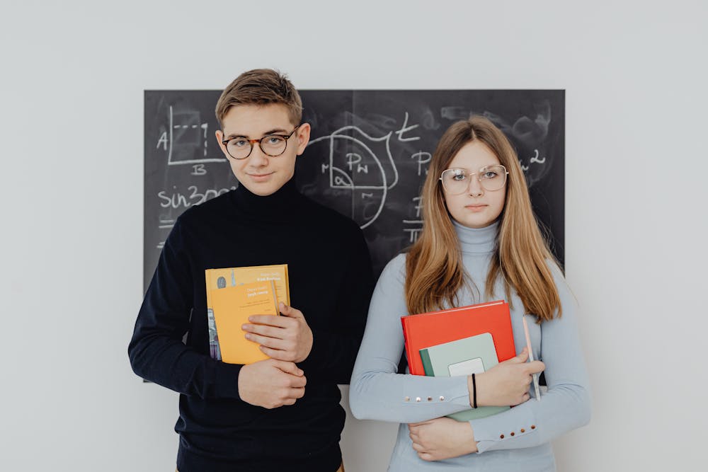 two junior high school students holding studying essentials