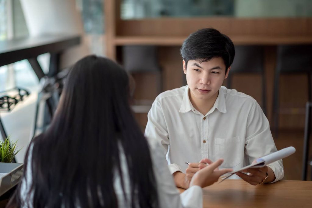 Student talking to an examiner during the Planned Response section of the English oral exam