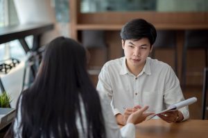 Student talking to an examiner during the Planned Response section of the English oral exam
