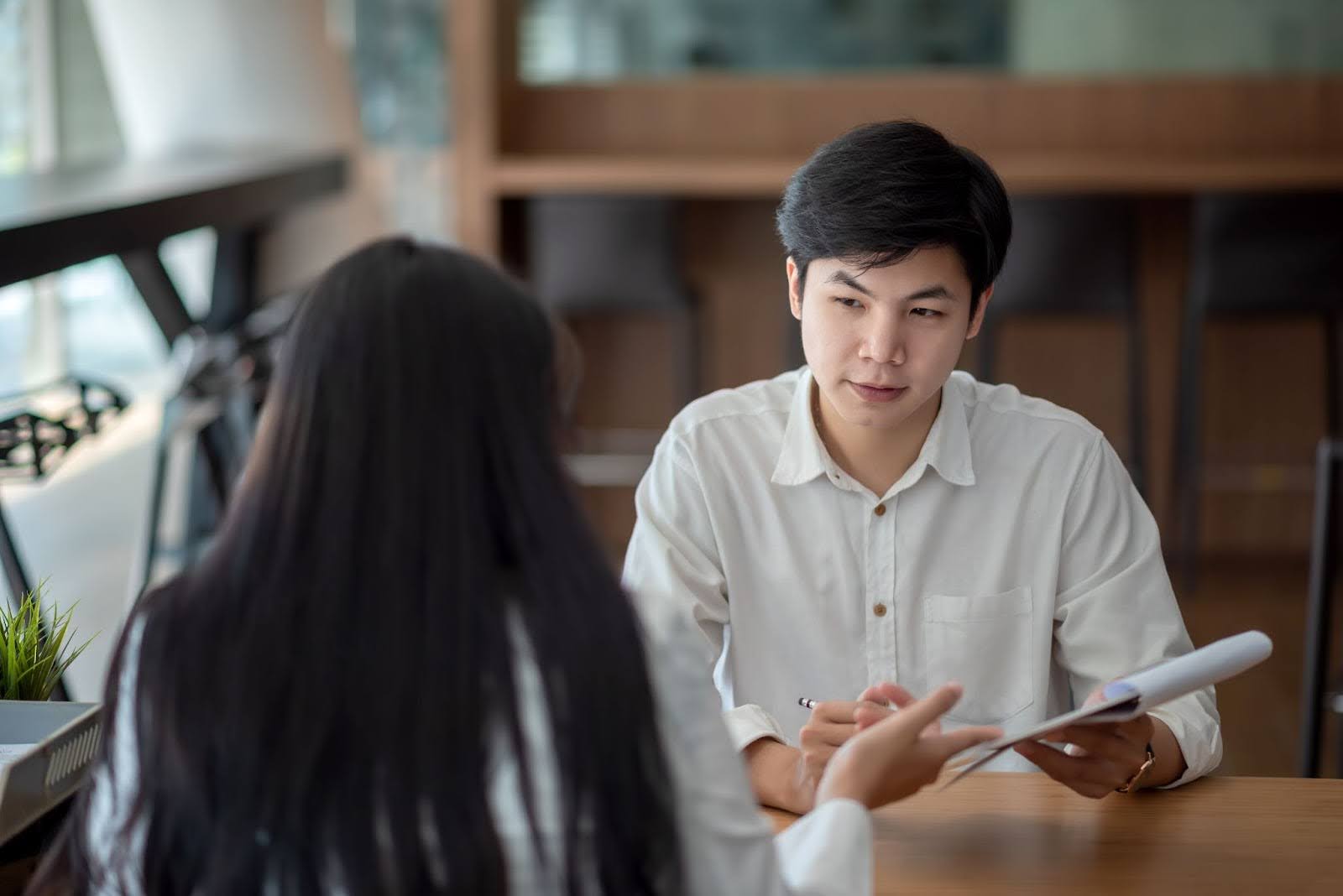 Student talking to an examiner during the Planned Response section of the English oral exam